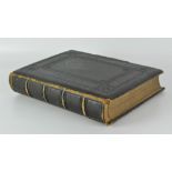 A late 19th century black and white photo album, containing mostly period portrait scenes,