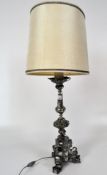 A silvered metal Italian Church candlestick-lamp with ornate moulding,