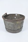 A large late 19th/early 20th century riveted metal circular bucket, with swing handle to top,