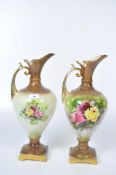 Two large vintage vases in the form of ewers, decorated with roses on a pale green ground,
