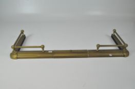 An adjustable yellow metal fender with railing to the sides,