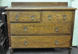 A 20th century oak cabinet, two small drawers above two larger drawers, all with metal handles,