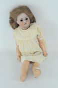 An early 20th century German doll, 12" 58", bisque head with painted features, eyes missing,