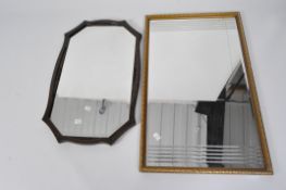 Two 20th century wall mirrors, comprising an Art Noveau example in an oak frame,