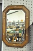 An octagonal oak framed bevel edge wall mirror,