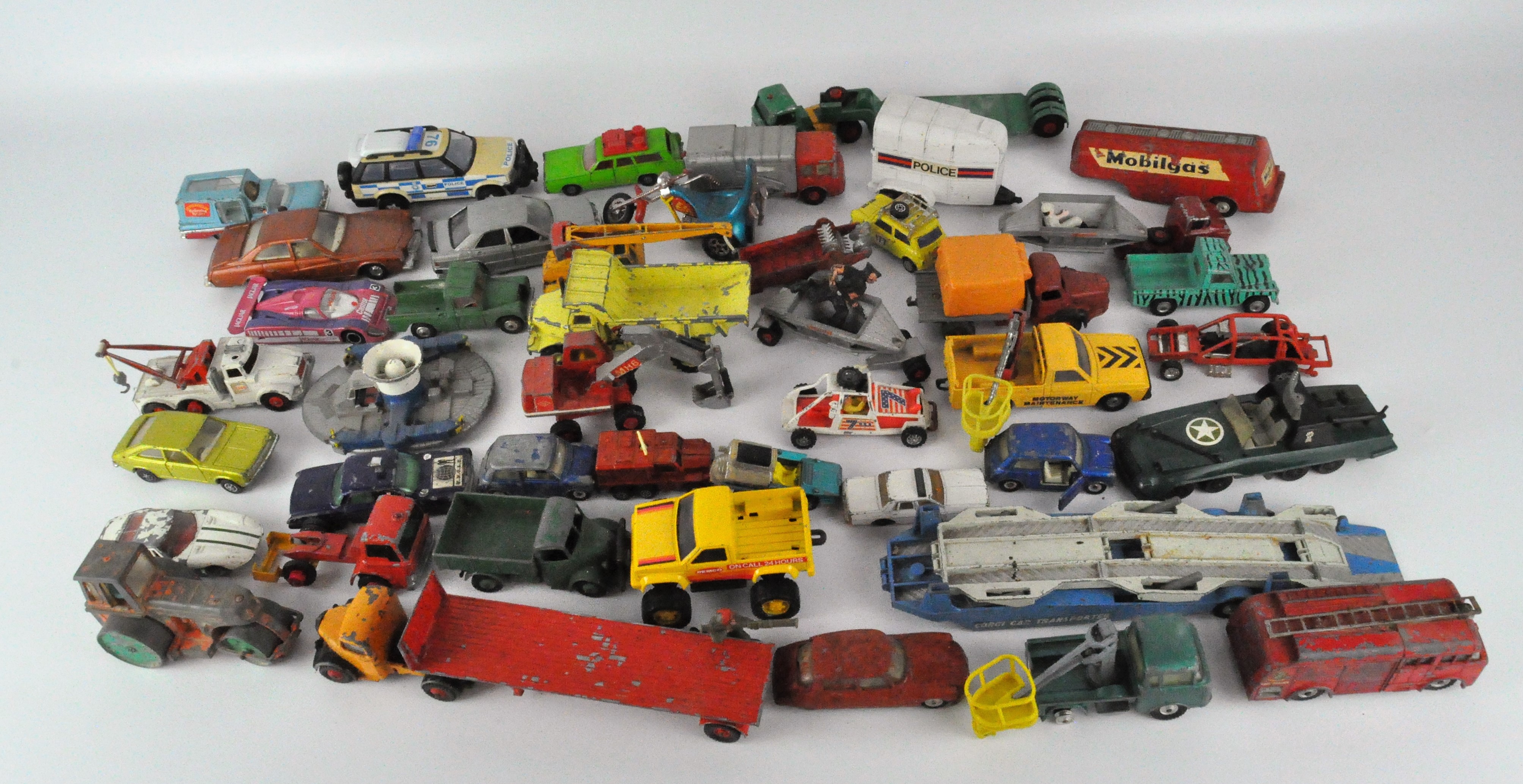 A collection of play worn Diecast vehicles, including examples by Corgi,