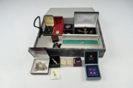 A collection of assorted silver and white metal jewellery, including brooches,