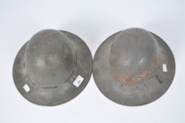 Two British WWII Home Defence Zuckerman helmets, one with lining stamped BMB 1941 and 7 in a shield,
