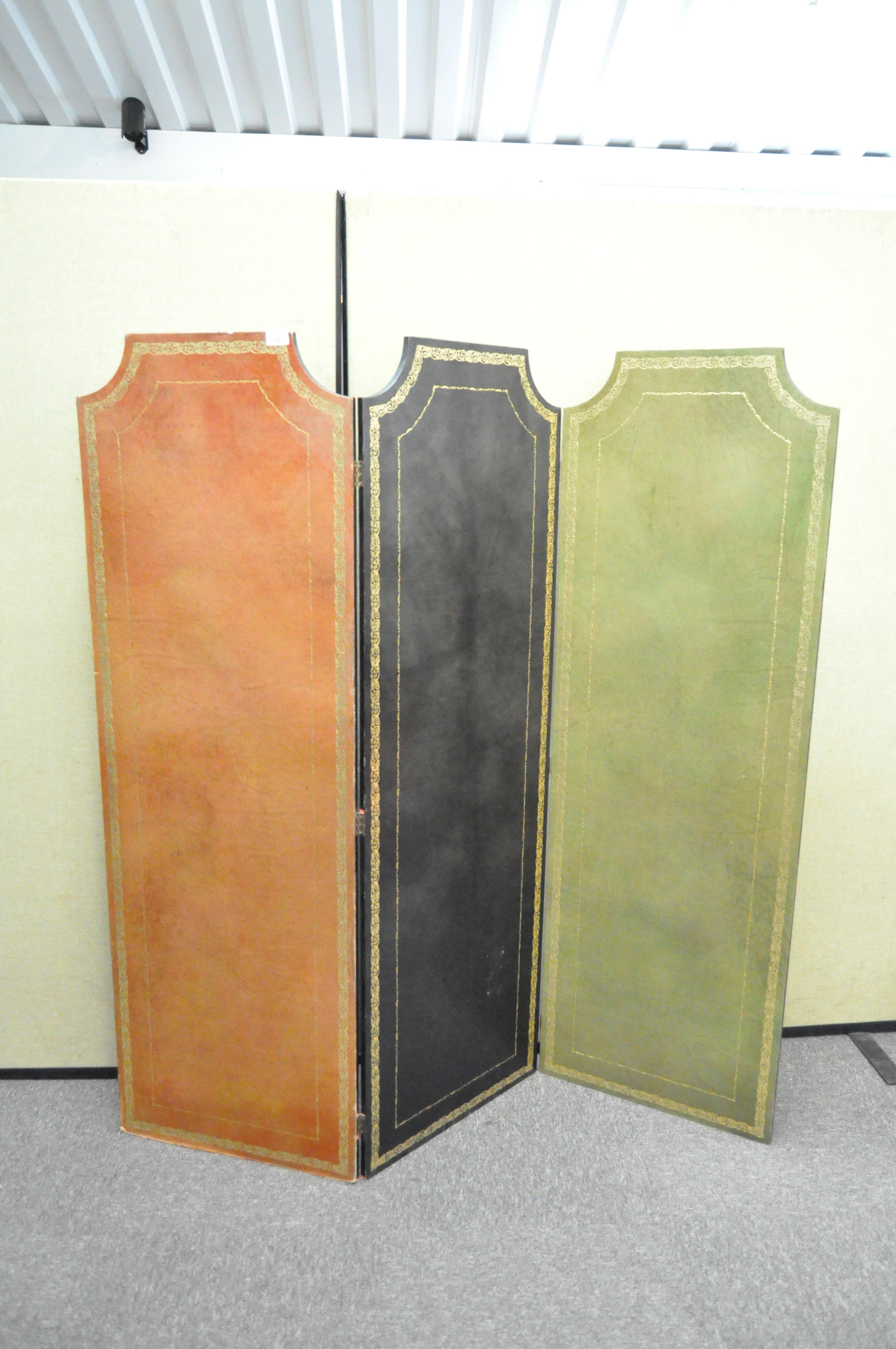 A 20th century three fold wooden screen, with leather detailing,