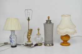 Five table lamps including three ceramic examples with cream shades,