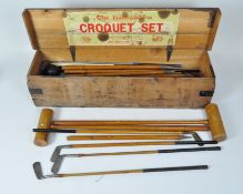 A John Jacques & Sons croquet set, together with some vintage golf clubs,