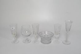 A small group of glassware including six drinking glasses with cut glass or engraved decoration