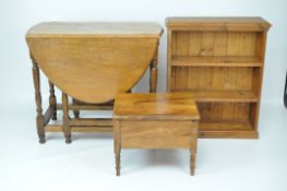 An oak oval gate leg table, 76.5cm x 91cm x 136cm; a pine bookcase with two shelves, 82.