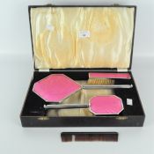 An Art Deco dressing table set, comprising two brushes, a comb and mirror,