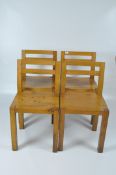 A set of four oak kitchen chairs of square minimalist form,