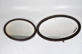 Two Victorian oval mirrors, one with bevelled edge, both with wooden frames,