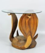 A novelty carved wooden three-cobra table with round glass top,
