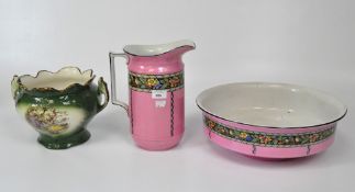 A vintage pink ceramic wash jug and basin with a frieze of birds and flowers,