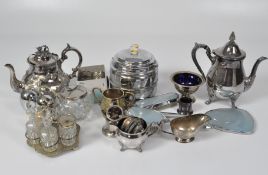 A collection of silver plate, including table lighters, teapots, a biscuit barrel, napkin rings,