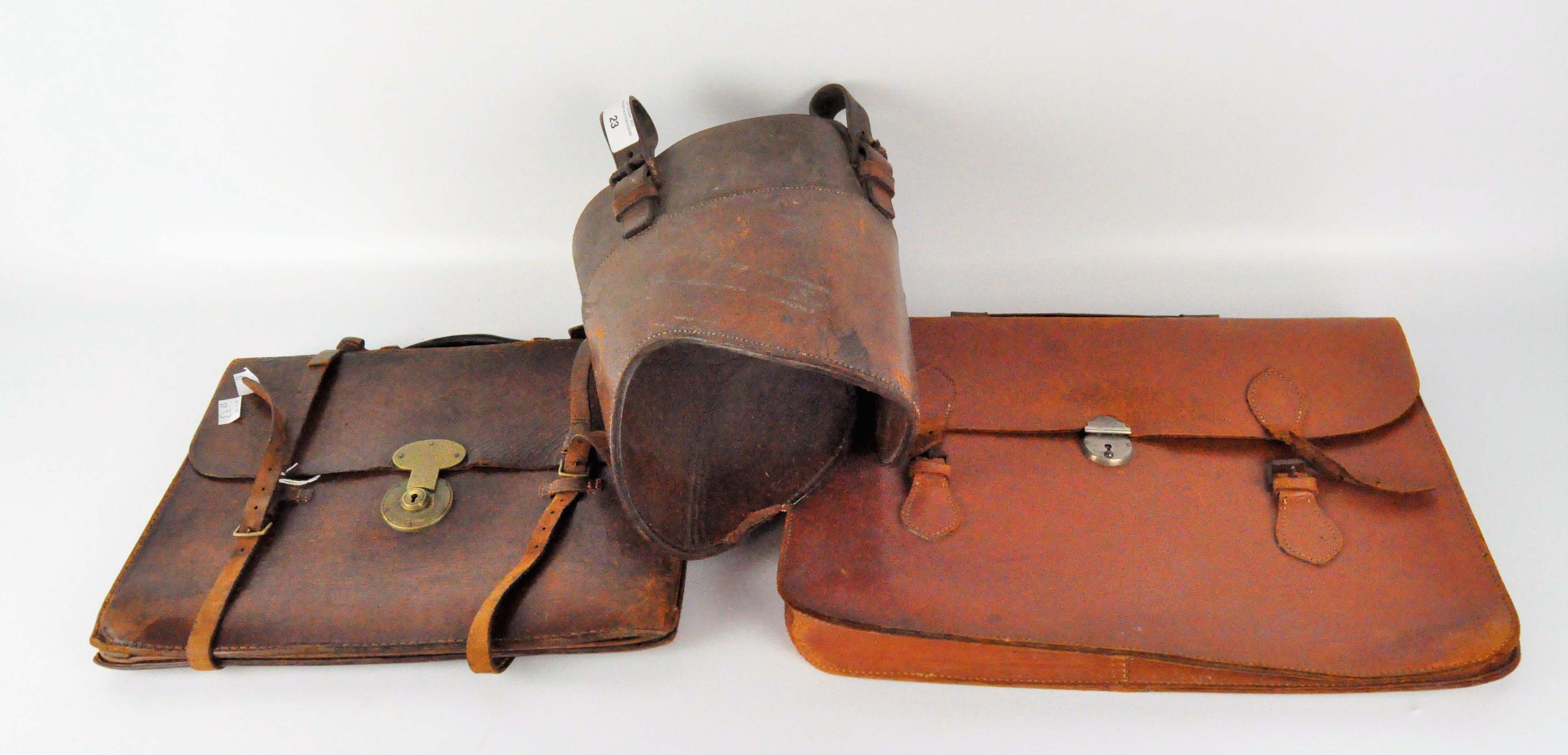 Two brown leather briefcases with metal fastenings;