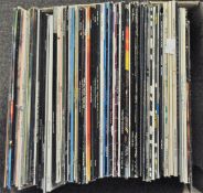 A collection of vinyl records, including works by David Bowie, Peter Gabriel and others,