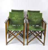 Four stained wood folding director's chairs with green textured upholstery,