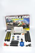 A Formula One Scalextric set, containing tracks, controllers and instructions,