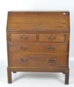 A early 20th century mahogany bureau, graduated drawers with metal handles to the front,