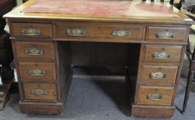 A Victorian walnut twin pedestal desk with two pillars of four drawers on casters,