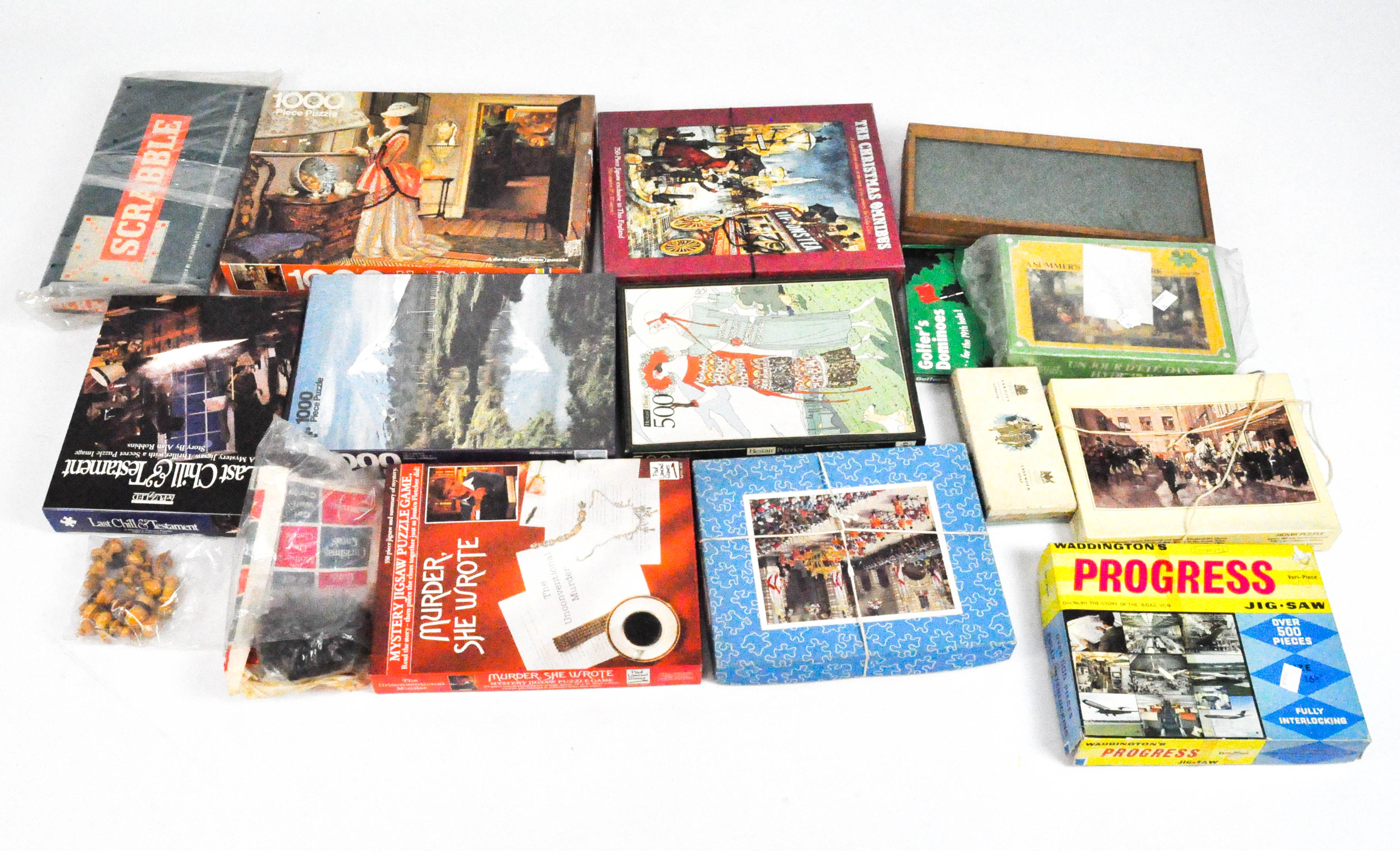 A collection of vintage games and puzzles, including Scrabble and jigsaw puzzles,