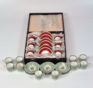 A cased Wedgwood 'Ulander' six-person coffee set with ruby red and gilt decoration,