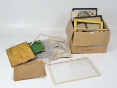 A quantity of picture framing materials including mounts, old frames, paper,