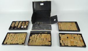 An early 20th century Chinese mah-jong set, carved bamboo pieces,