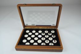 A glazed display case containing a selection of silver rings, of varying designs,