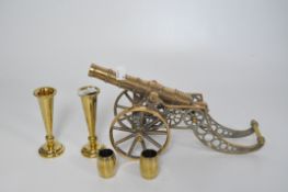 A brass model of a cannon with a tilt mechanism and rolling wheels, and more