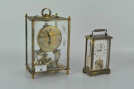 A contemporary Kundo carriage clock, in a brass skeleton case,