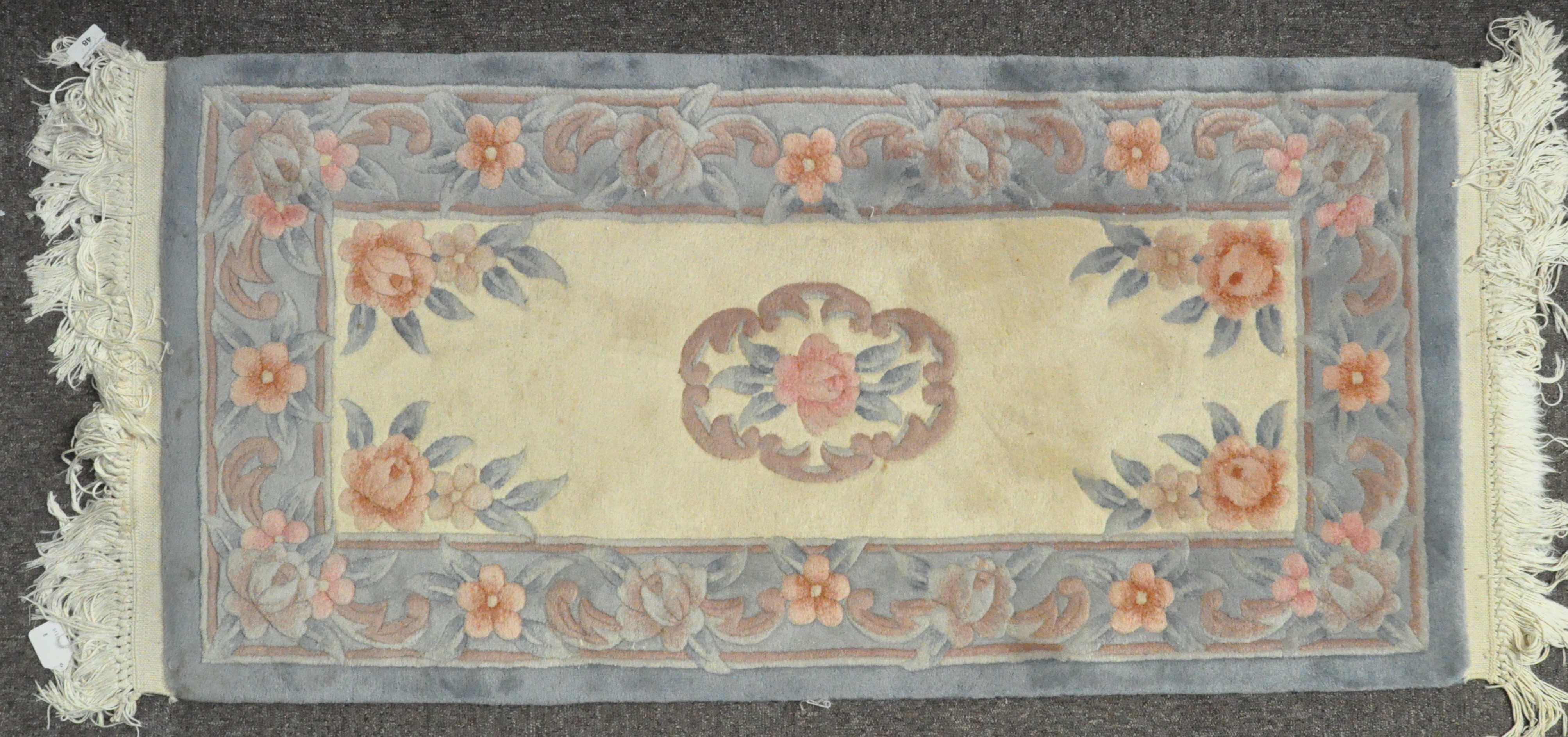 A small Chinese rug, 20th century, woven with flowers on ivory cream ground, - Image 2 of 2