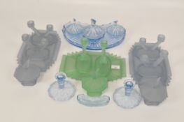 A collection of coloured Art Deco style glassware, including candlesticks,