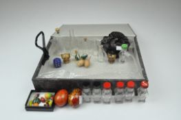 An assortment of items, including small glass bottles, painted eggs,