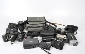 A collection of cameras, lenses and accessories, including an Olympus OM10, Zenit,