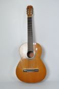 A vintage acoustic guitar, label to the inside reading BM Limited Espana,