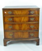 A reproduction mahogany veneer bow front chest of four drawers on bracket feet,
