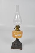 A 20th century oil lamp, the metal base with pierced decoration of birds,
