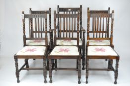 A set of five oak dining chairs, spindle backs with carved decoration and turned wooden supports,