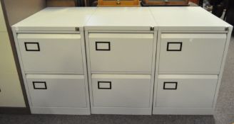 Three contemporary filing cabinets, constructed of grey metal, each with two sliding drawers,