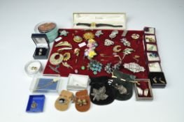 A selection of assorted costume jewellery, including brooches,
