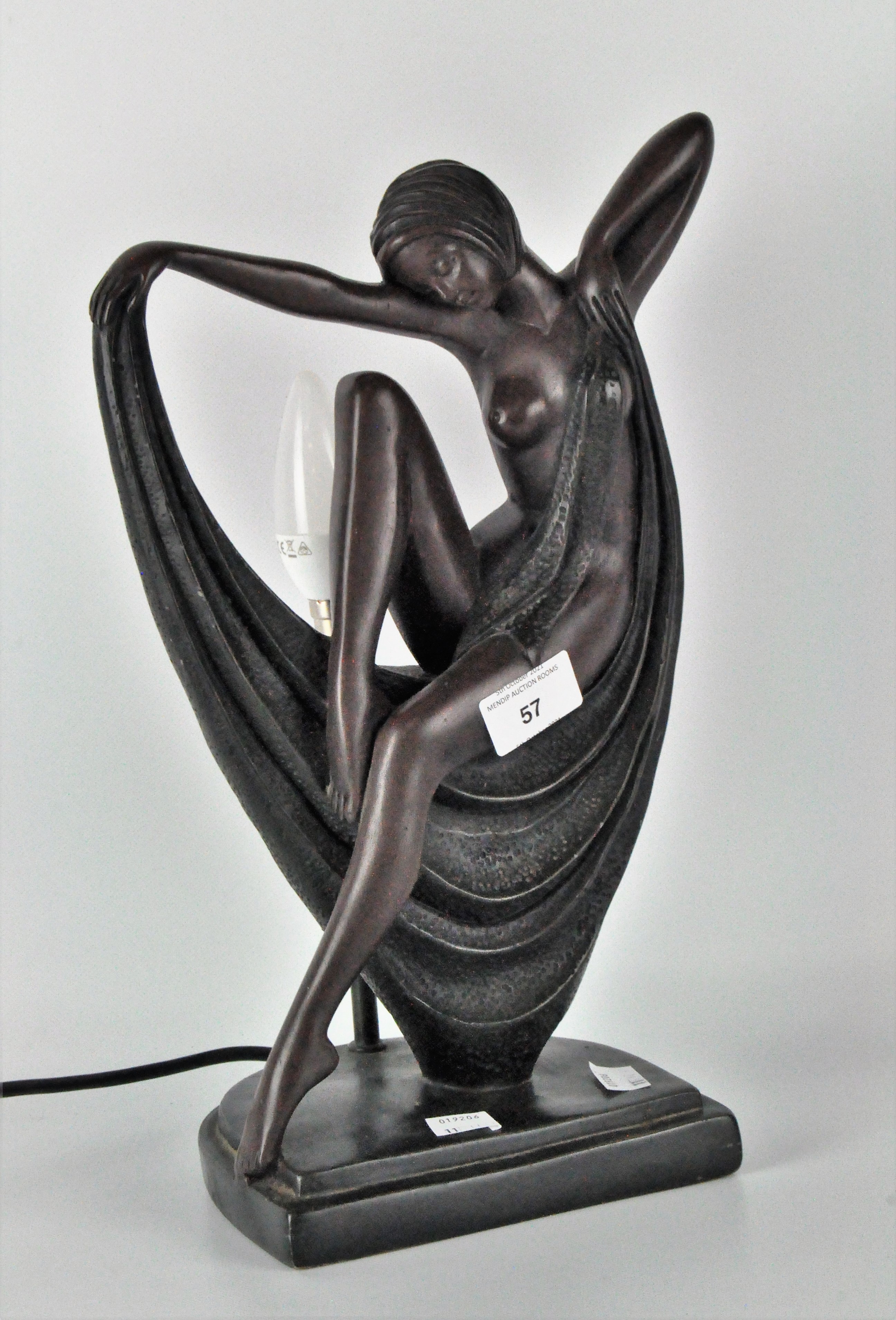 A modern bronze affect table lamp depicting a lady in the Art Deco style,