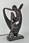 A modern bronze affect table lamp depicting a lady in the Art Deco style,