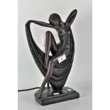 A modern bronze affect table lamp depicting a lady in the Art Deco style,