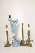 A light blue glazed stoneware lamp stand modelled as a woman,